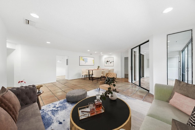 tiled living room with a textured ceiling