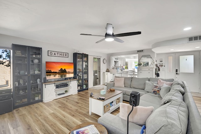 living room with ceiling fan and light wood-type flooring