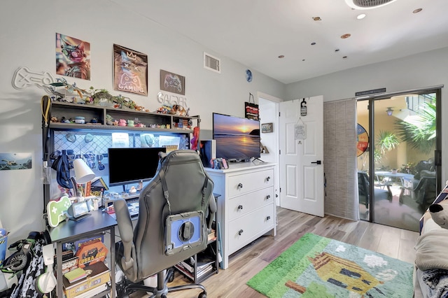 home office featuring light wood-type flooring and a healthy amount of sunlight