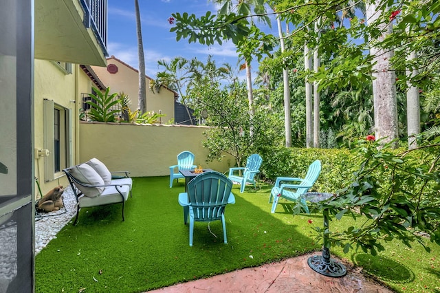 view of yard featuring a fire pit and a patio