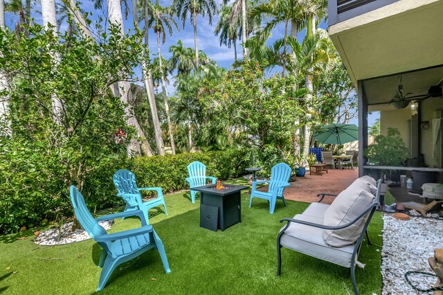 view of yard featuring a patio and an outdoor fire pit