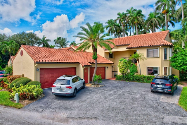 mediterranean / spanish home with a garage