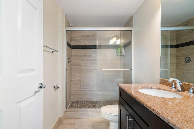 bathroom featuring walk in shower, vanity, and toilet