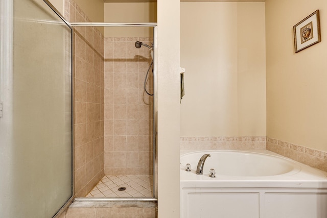 bathroom featuring shower with separate bathtub