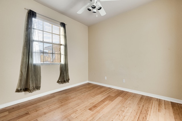 spare room featuring wood-type flooring and ceiling fan