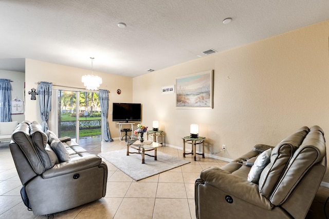 living room featuring an inviting chandelier, a textured ceiling, and light tile patterned floors