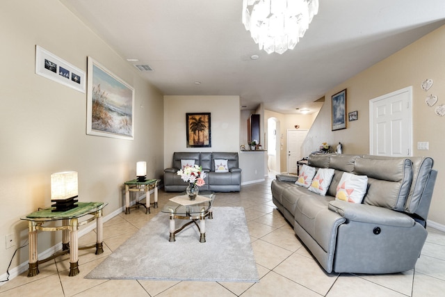 tiled living room featuring a notable chandelier