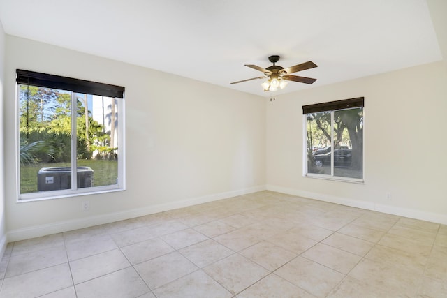 tiled spare room with ceiling fan