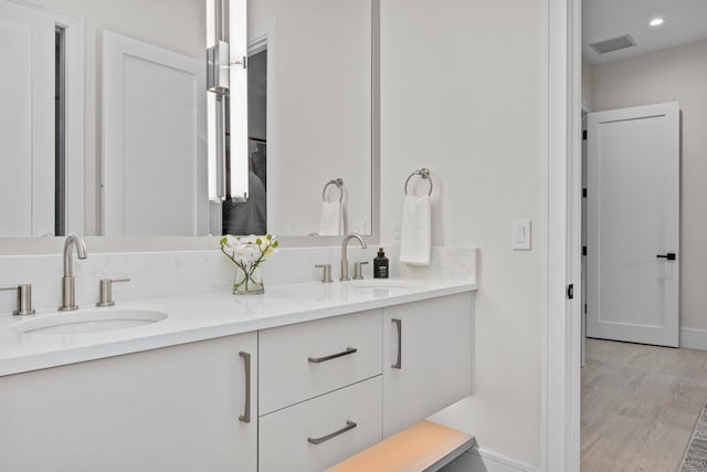 bathroom featuring vanity and wood-type flooring