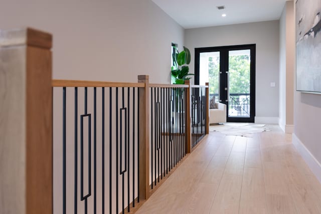 hallway featuring french doors and light hardwood / wood-style flooring