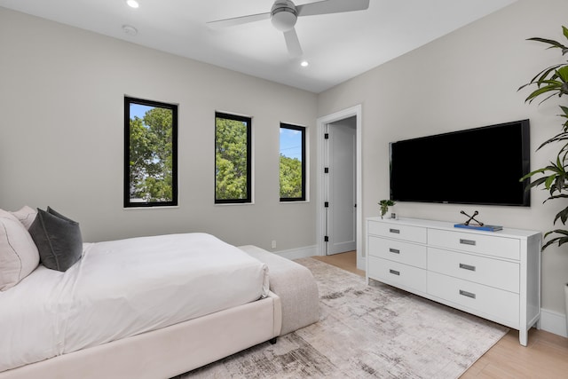 bedroom featuring ceiling fan and light hardwood / wood-style flooring