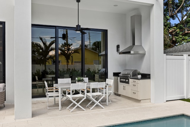 view of patio with area for grilling and ceiling fan