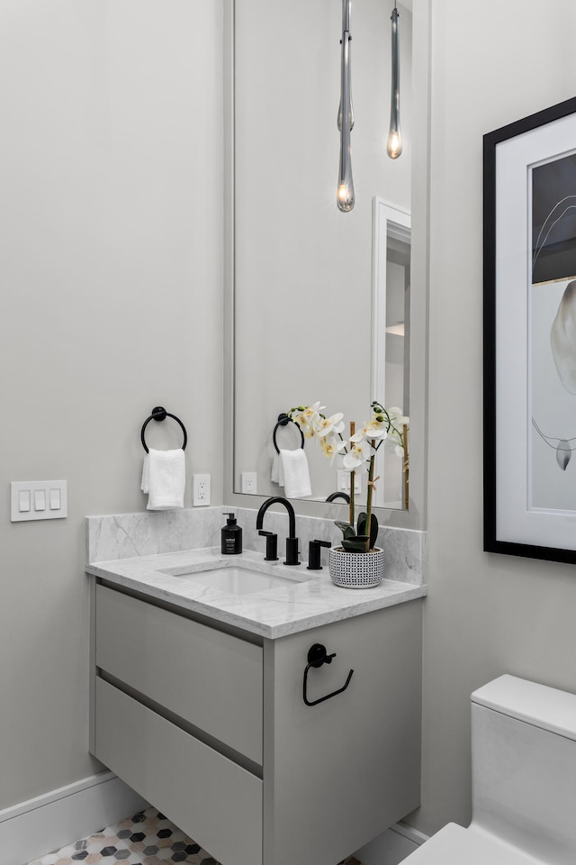 bathroom featuring vanity and toilet