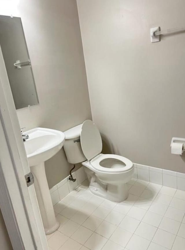 bathroom featuring sink, toilet, and tile patterned floors