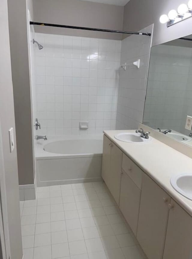 bathroom with tiled shower / bath combo, vanity, and tile patterned floors