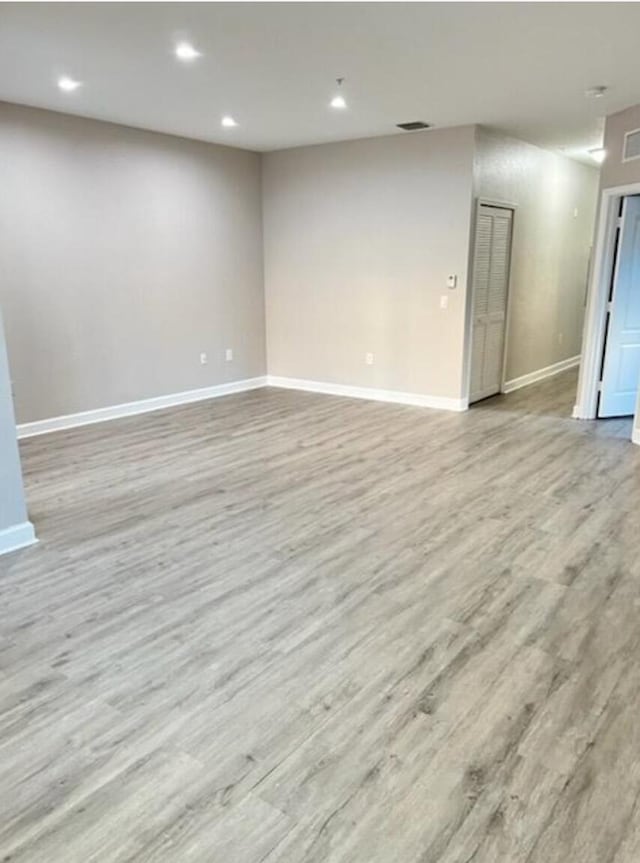 spare room with light hardwood / wood-style floors