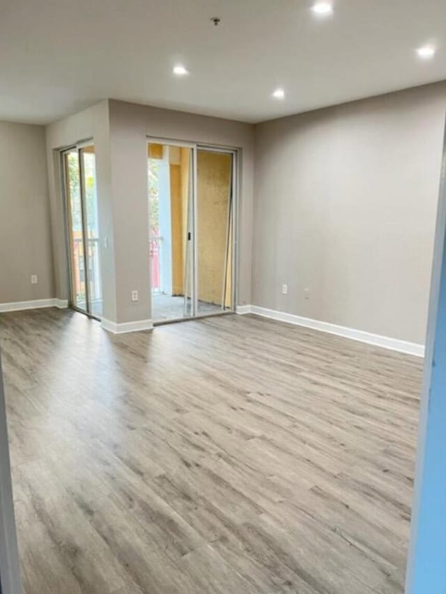 unfurnished room with light hardwood / wood-style floors