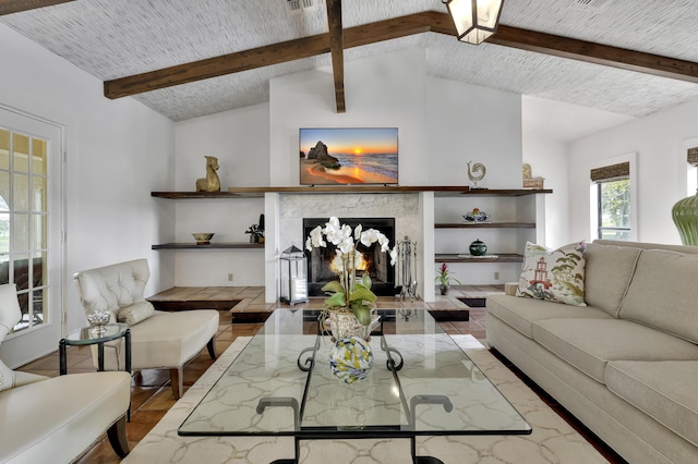 living room with a high end fireplace and lofted ceiling with beams