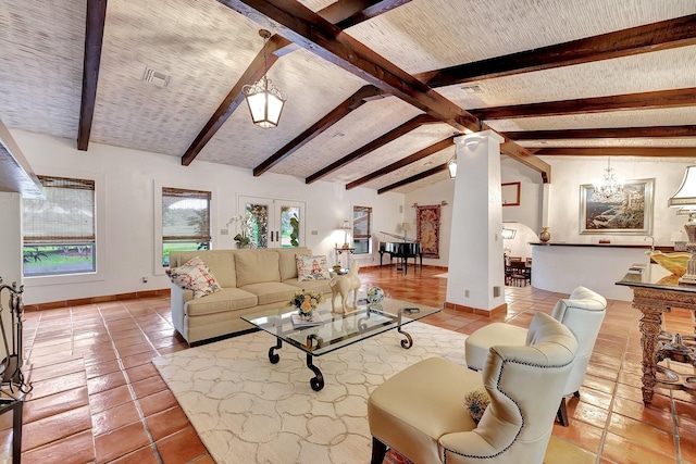 tiled living room with vaulted ceiling with beams, a chandelier, and french doors