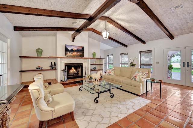 living room featuring vaulted ceiling with beams, a premium fireplace, plenty of natural light, and french doors