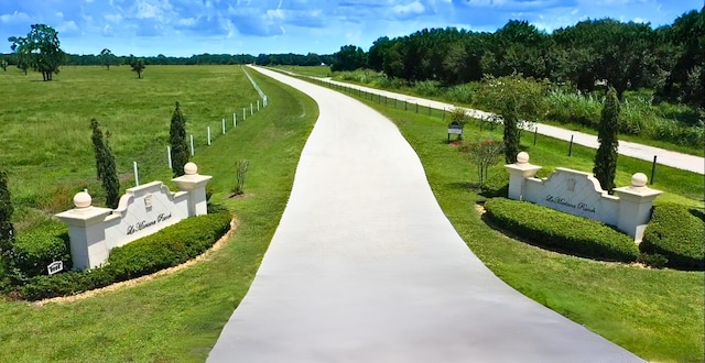 view of community with a yard and a rural view