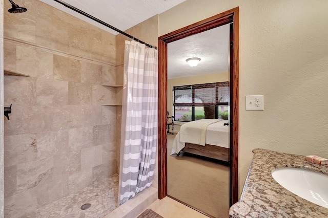 bathroom featuring vanity, a shower with curtain, and a textured ceiling