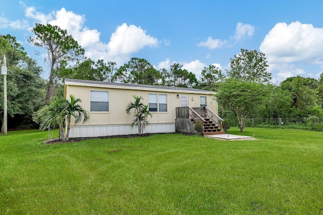 back of property featuring a yard