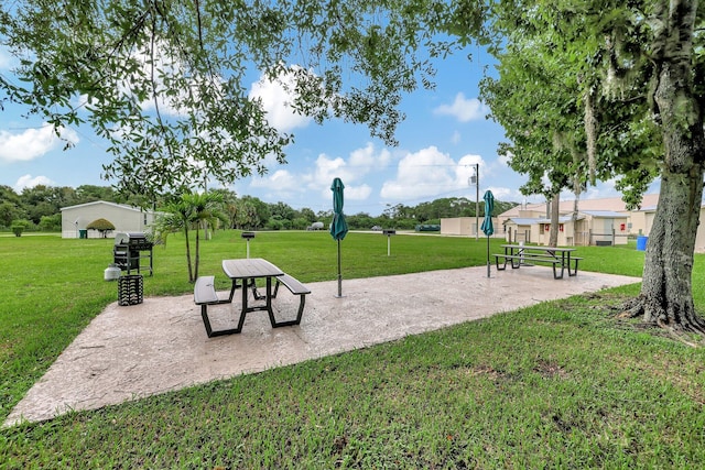 view of home's community featuring a patio and a lawn