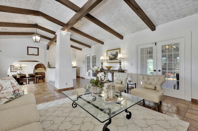 living room with a chandelier, french doors, light tile patterned flooring, and lofted ceiling with beams