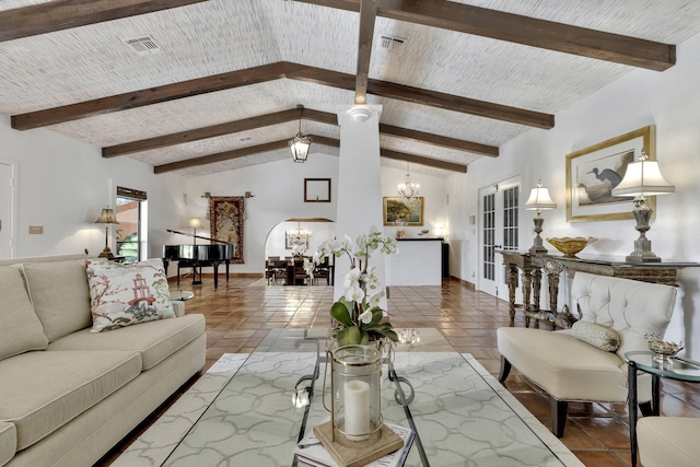 tiled living room featuring vaulted ceiling with beams and a chandelier