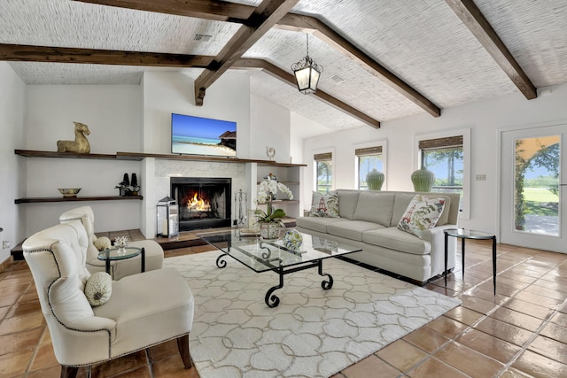 living room featuring light tile patterned floors, vaulted ceiling with beams, and a premium fireplace