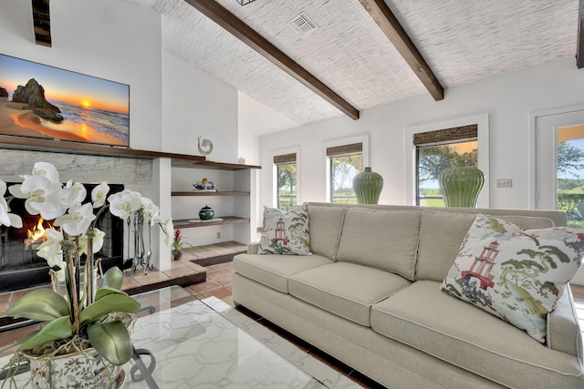 living room featuring a stone fireplace and lofted ceiling with beams