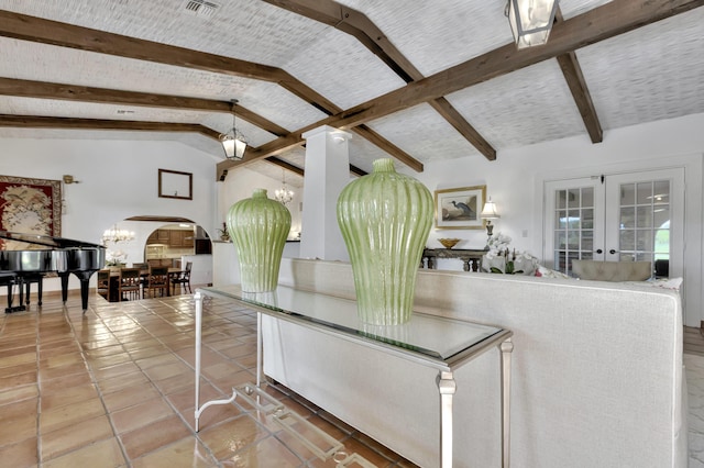 tiled living room with french doors, lofted ceiling with beams, and an inviting chandelier