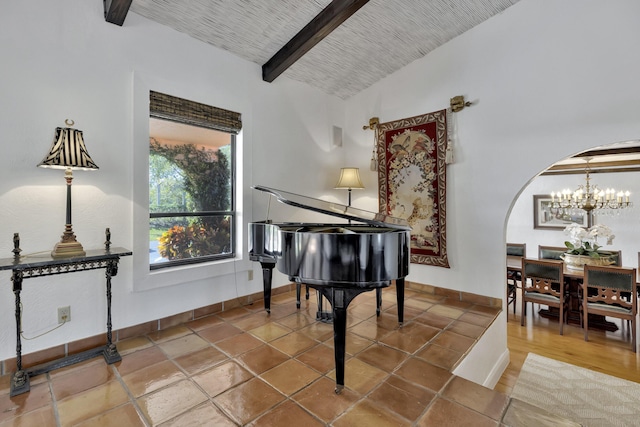 miscellaneous room featuring tile patterned flooring, vaulted ceiling with beams, and an inviting chandelier