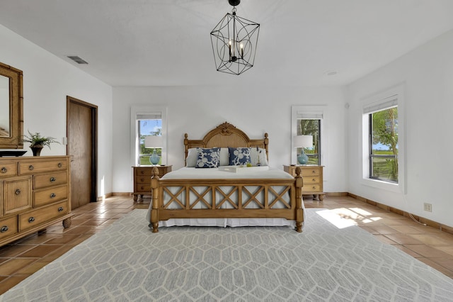 bedroom featuring a chandelier and light tile patterned floors