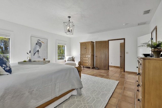 tiled bedroom featuring a chandelier and multiple windows