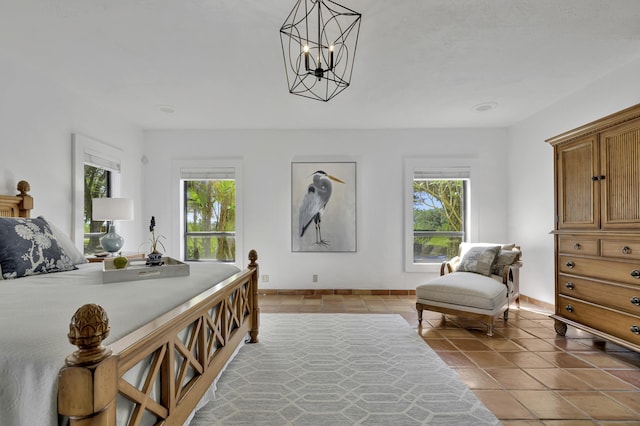 tiled bedroom with a notable chandelier