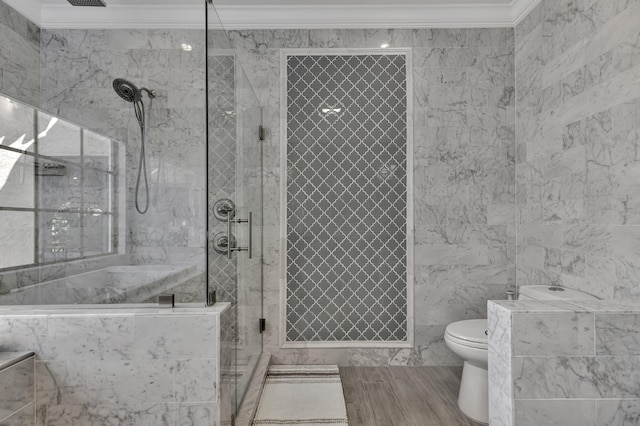 bathroom with toilet, a shower with door, tile walls, and ornamental molding