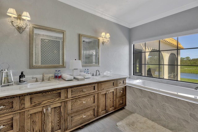 bathroom featuring vanity, a relaxing tiled tub, and ornamental molding