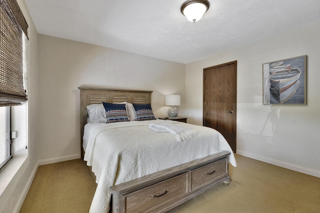 carpeted bedroom with a textured ceiling