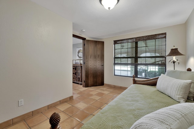 bedroom featuring light tile patterned flooring