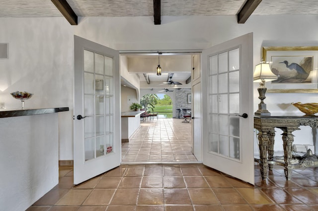 entryway featuring beamed ceiling, french doors, tile patterned flooring, and ceiling fan