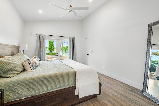 bedroom with wood finished floors, french doors, high vaulted ceiling, baseboards, and access to outside