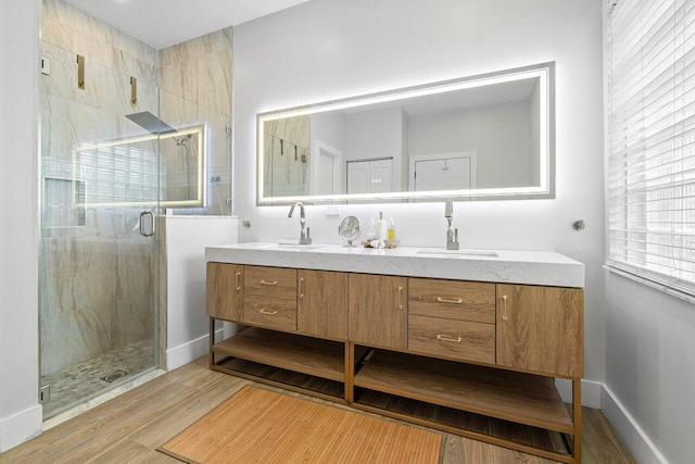 bathroom featuring walk in shower, wood-type flooring, and vanity