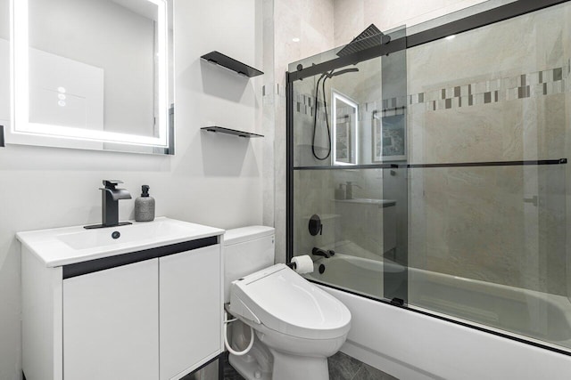 full bathroom featuring toilet, vanity, and combined bath / shower with glass door