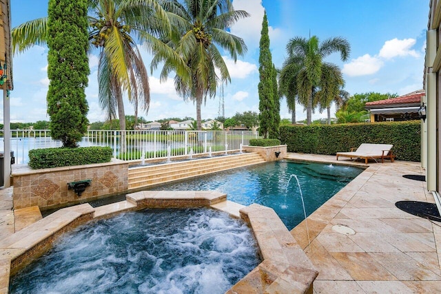 view of swimming pool with a patio, an in ground hot tub, a water view, and pool water feature