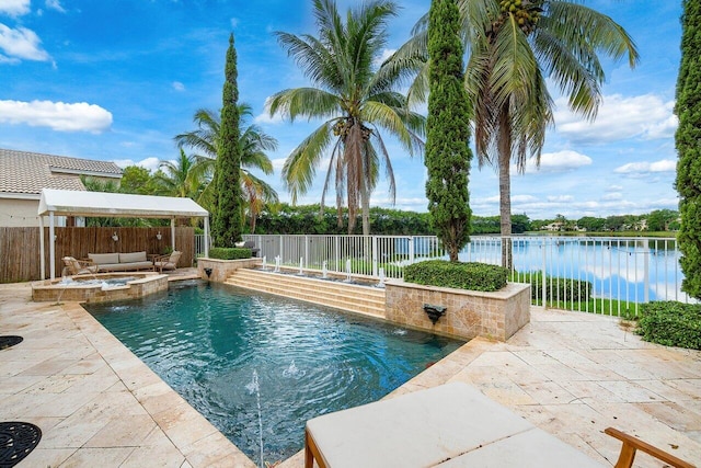 view of swimming pool featuring a patio area, a water view, and a fenced backyard