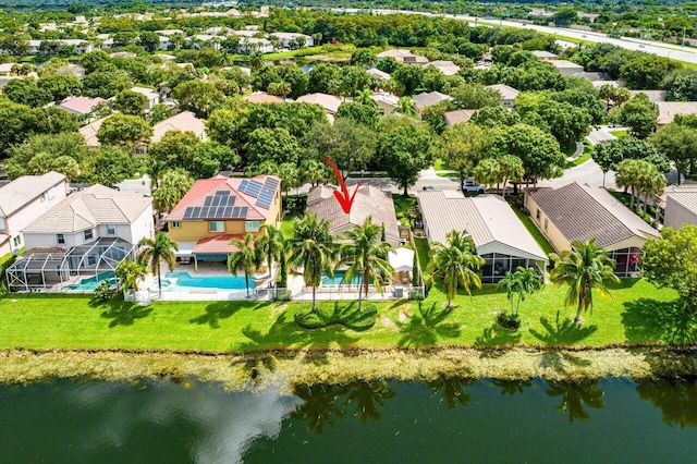 birds eye view of property with a water view and a residential view