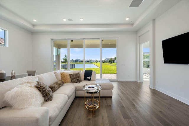 living room featuring a wealth of natural light and dark hardwood / wood-style floors