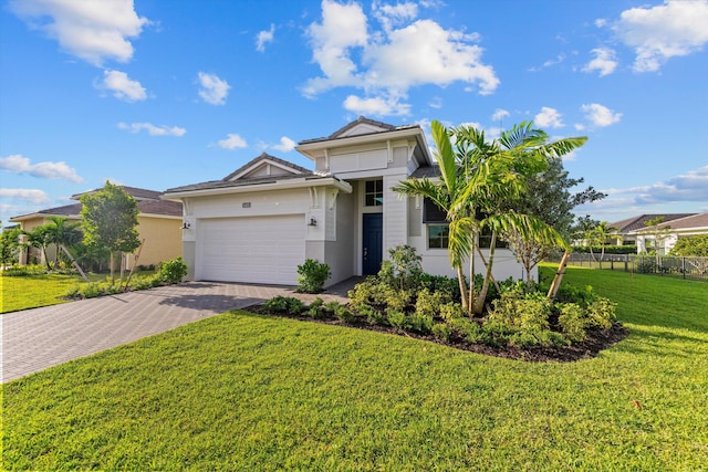 view of front of house featuring a front yard and a garage